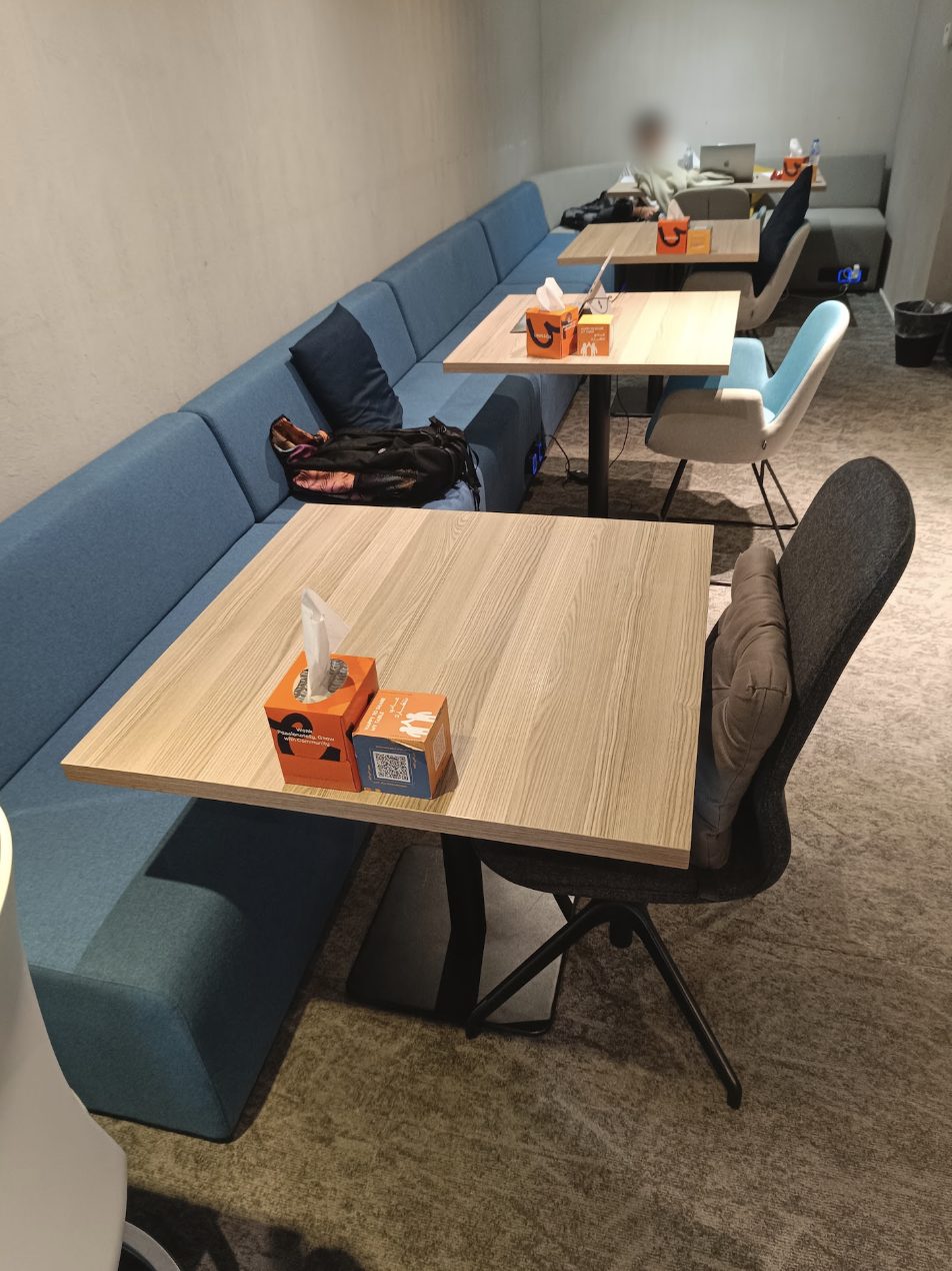 Quiet study lounge with long blue bench and wooden tables